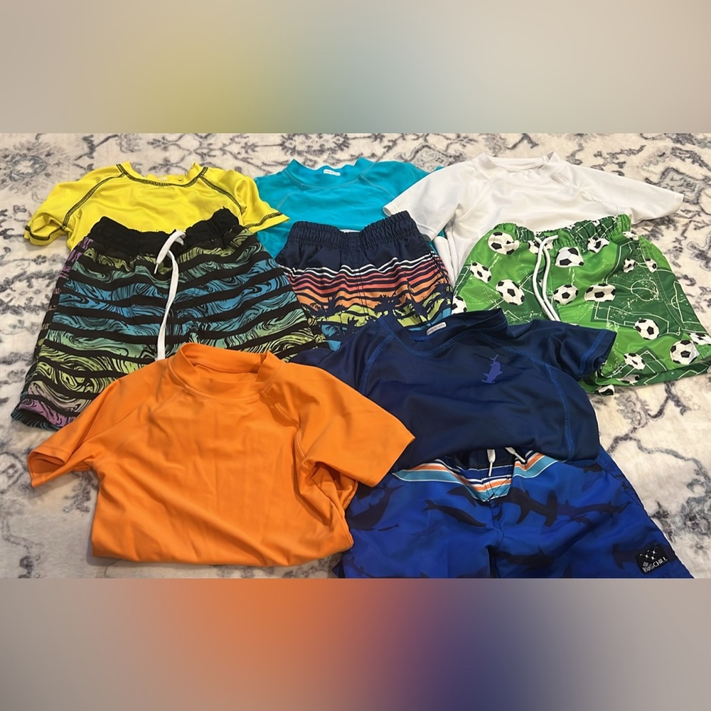 Bundle of boys swim trunks and rash guards